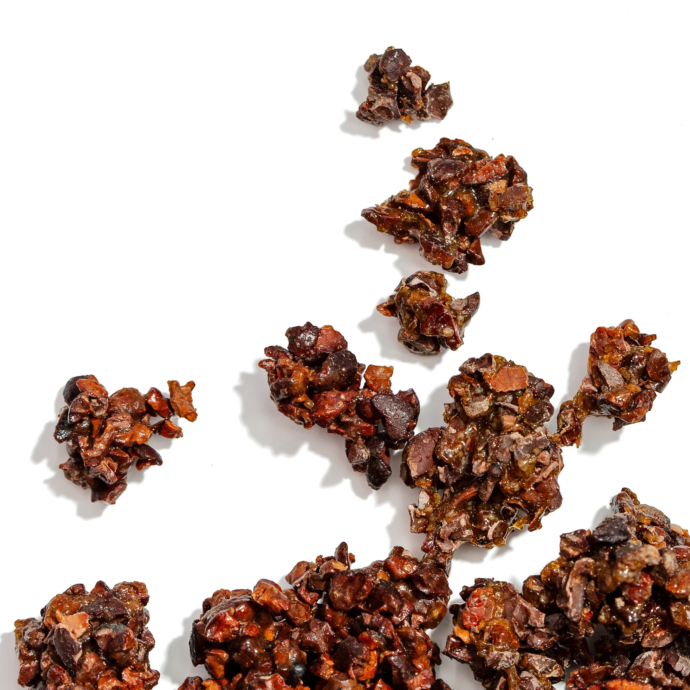 Dark chocolate truffles scattered on a white background