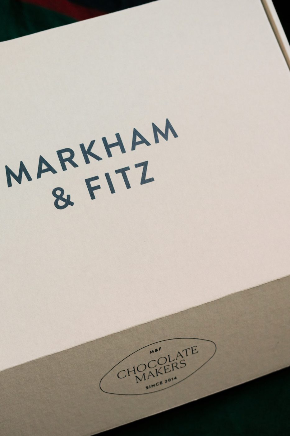 Close-up of the white Markham & Fitz mailer with its Chocolate Makers seal