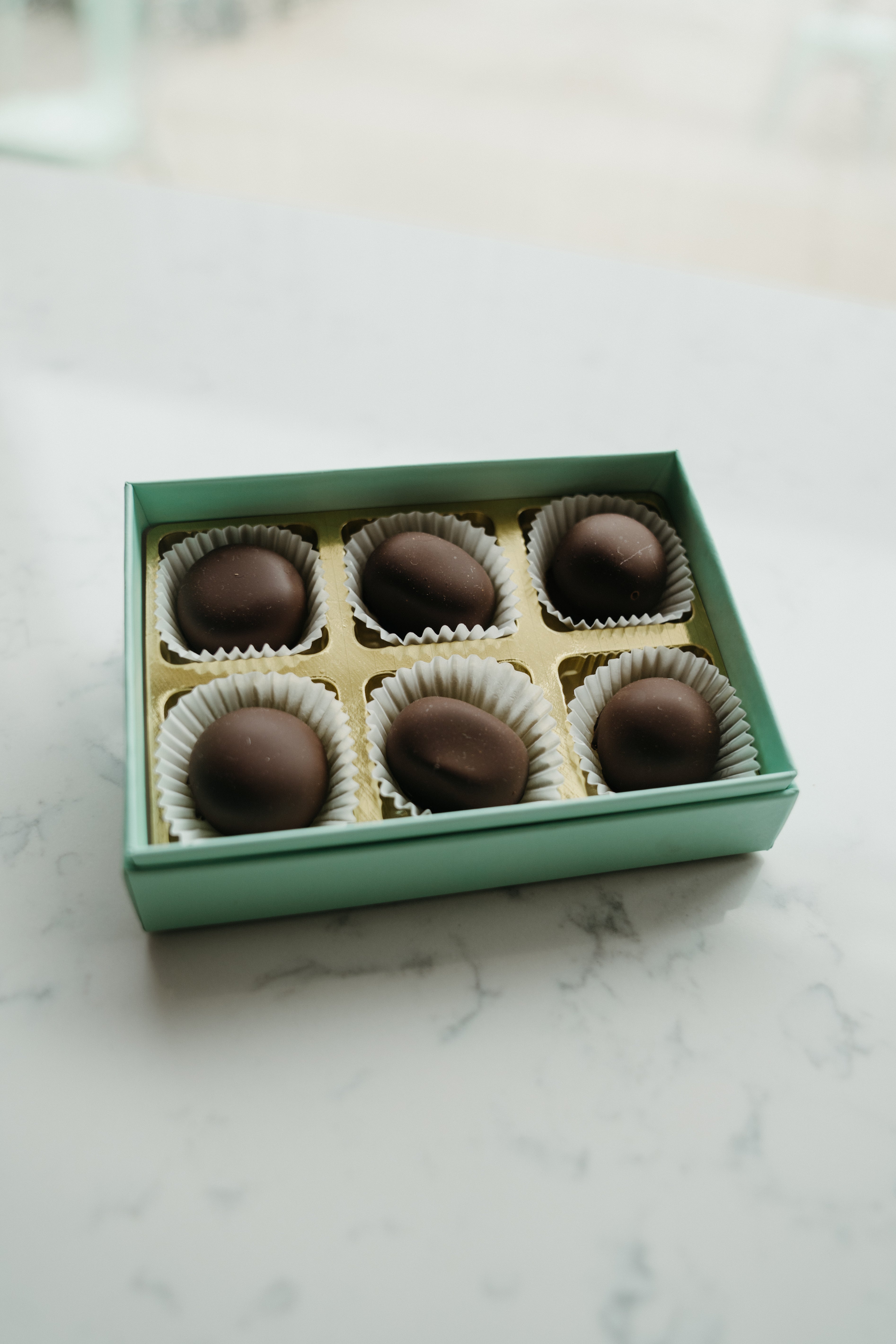 Box of chocolates on a marble surface